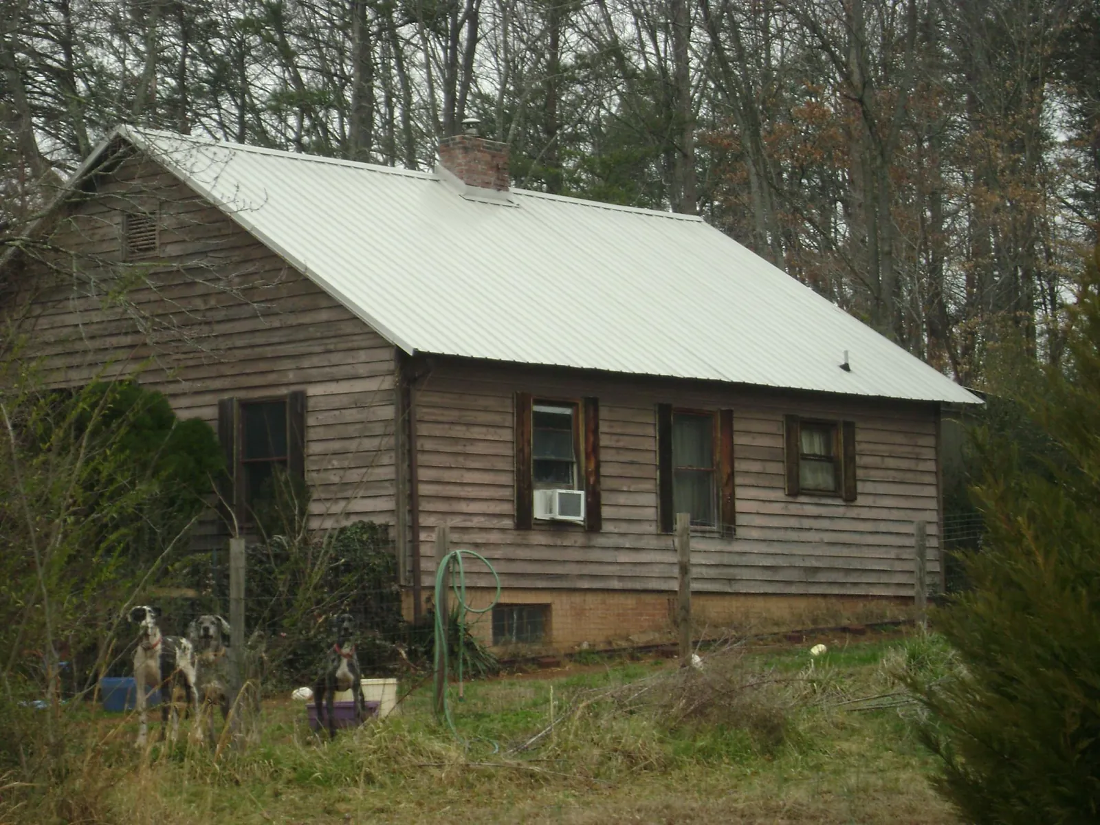 White metal roof on an old wood sided farmhouse, from a Metal Roof Installation job in Elderton